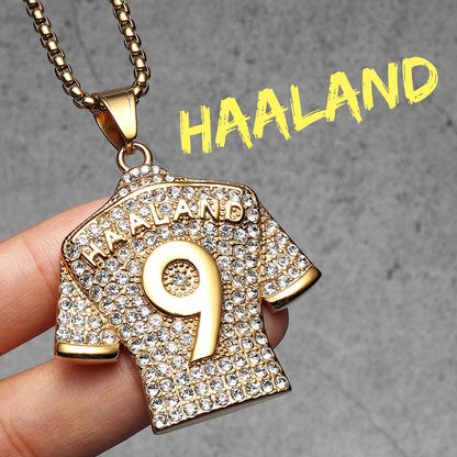 Gold necklace pendant shaped like a sports jersey with 'HAALAND' and number '9' on a grey background.