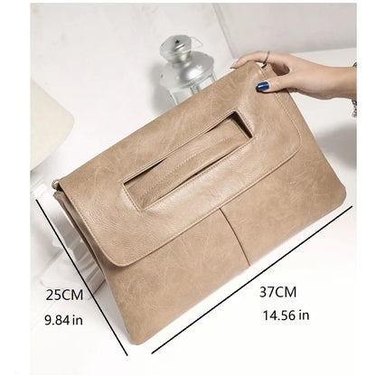 Beige clutch bag held by a hand with measurements displayed