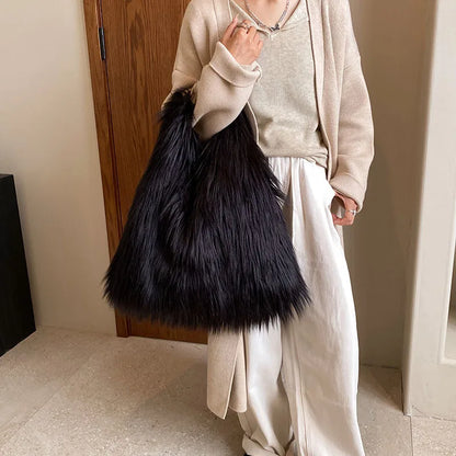 Person holding a black fluffy bag indoors
