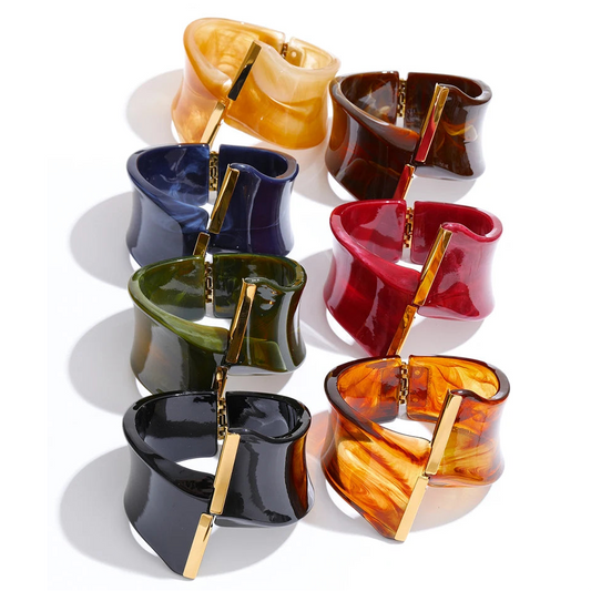 Set of colourful bracelets with gold accents on a white background