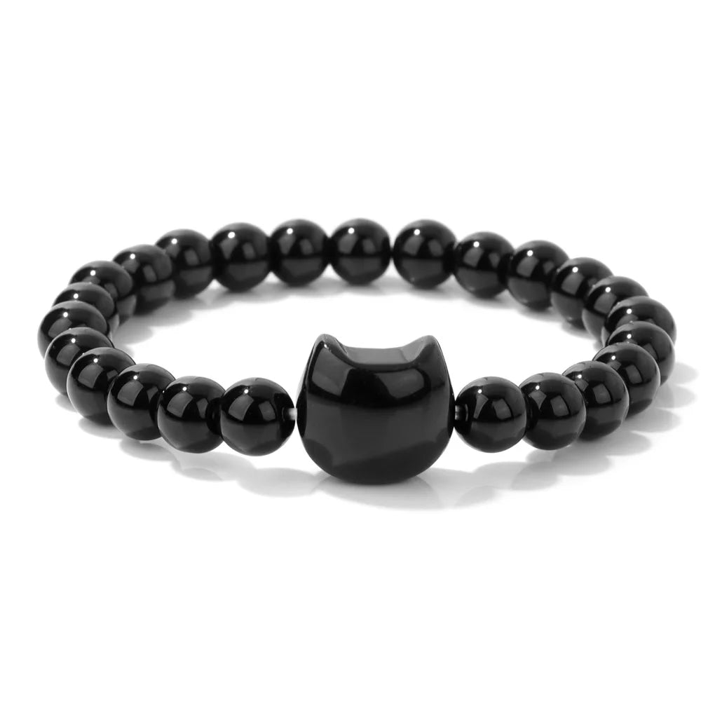 Black beaded bracelet with a cat-shaped charm on a white background