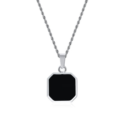 Silver necklace with a black pendant on a white background