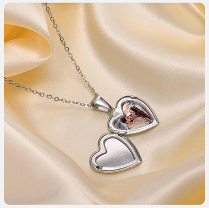 Silver heart-shaped pendant necklace on a satin background