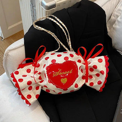 Decorative bags with red polka dots and 'Sweet' text on a black garment.