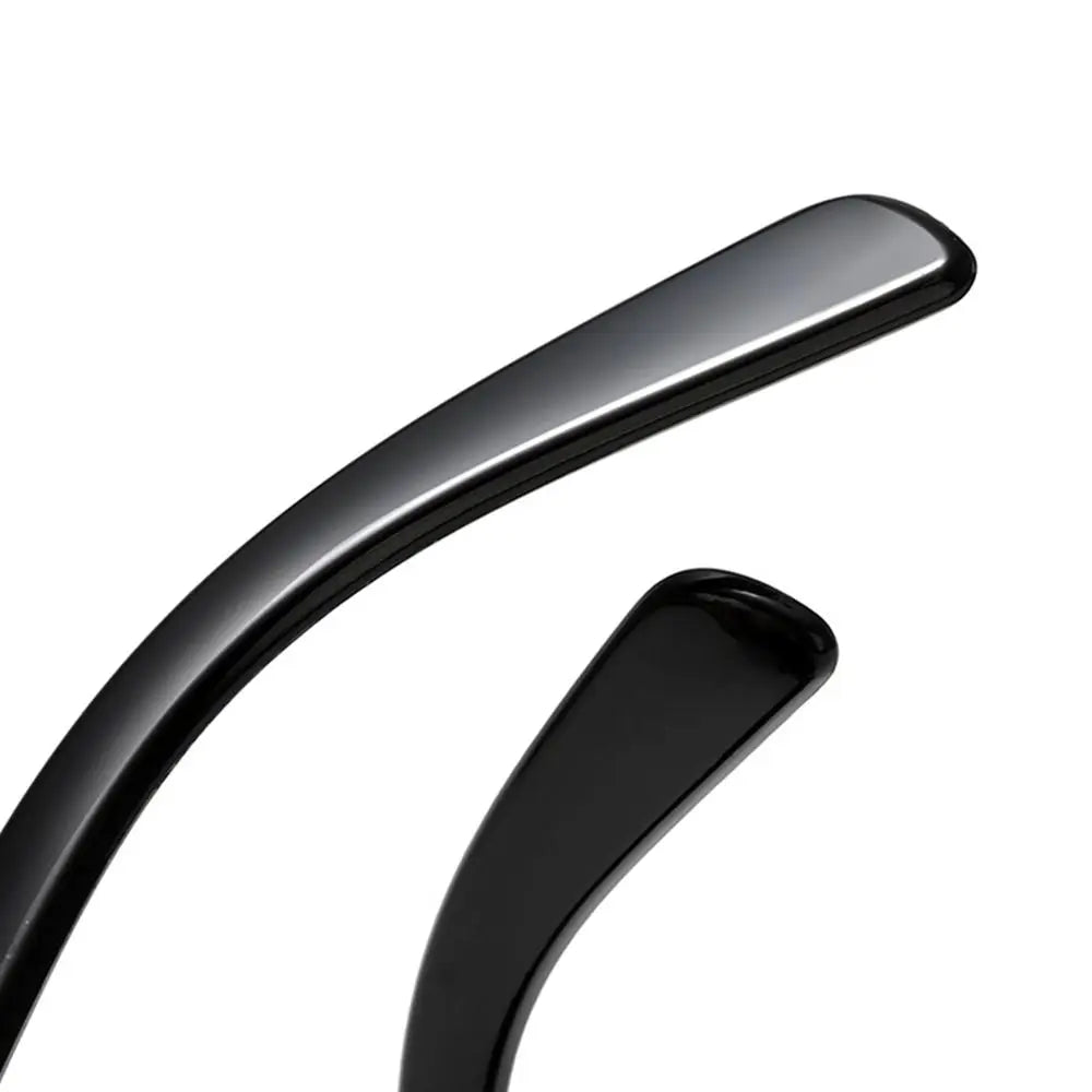 Two black curved sunglasses temples on a white background