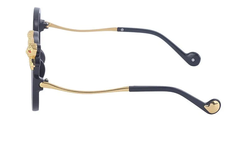 Eyeglass frame with black and gold details on a white background