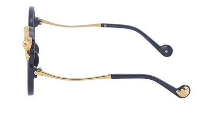 Eyeglass frame with black and gold details on a white background