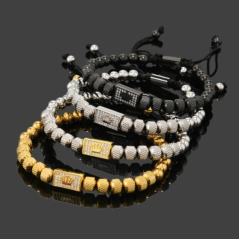 Stack of beaded bracelets with gold and silver accents on a reflective surface.
