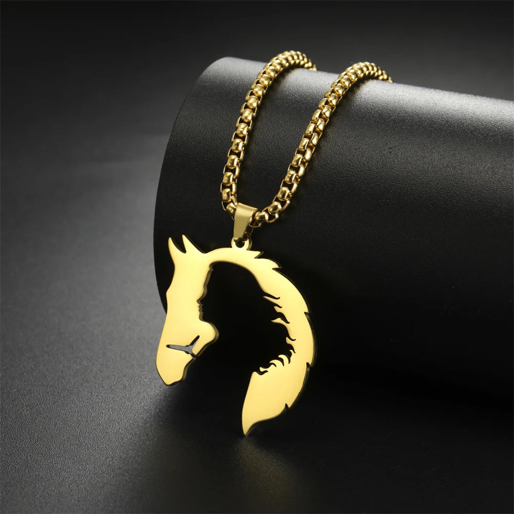 Gold horse head pendant on a black background