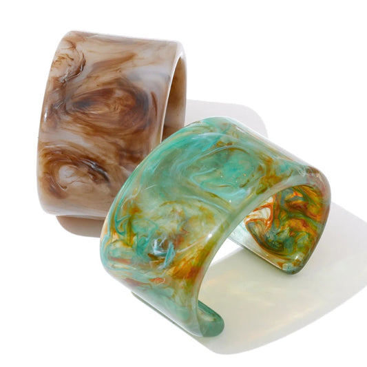 Two marbled patterned bracelets on a white background