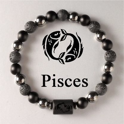 Black beaded bracelet with Pisces symbol on a light grey background