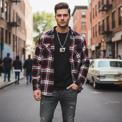 Man wearing a plaid shirt and black t-shirt with a necklace with the number 67 on a city street.