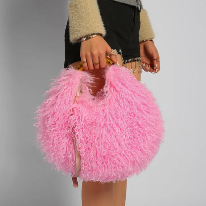 Person holding a pink fluffy handbag against a neutral background