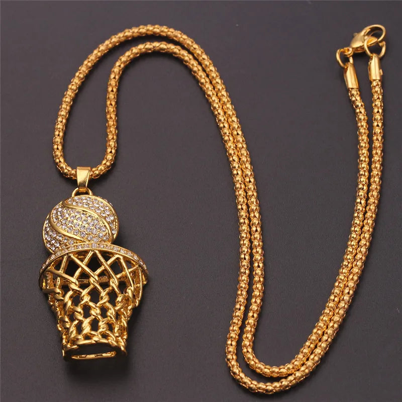 Gold necklace with basketball hoop and ball pendant on a dark background
