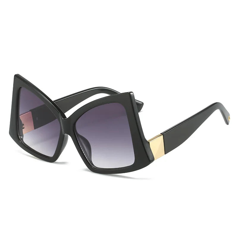 Black sunglasses with gold accents on a white background