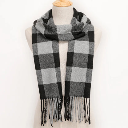 Plaid scarf with black and grey pattern on a mannequin against a white background