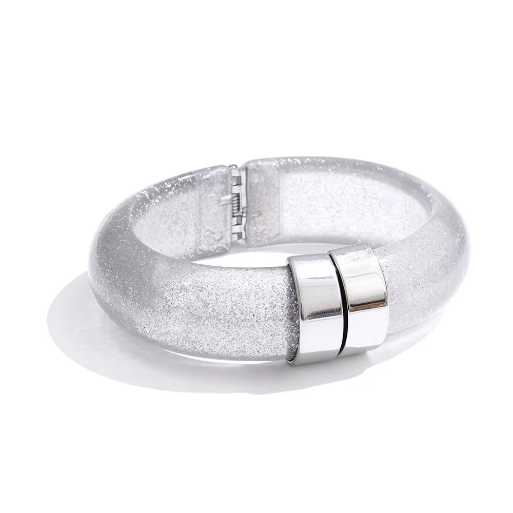 Silver bracelet with glittery finish on a white background