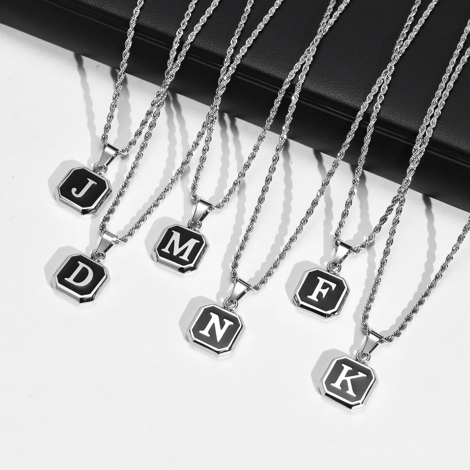 Set of necklaces with letter pendants on a white background
