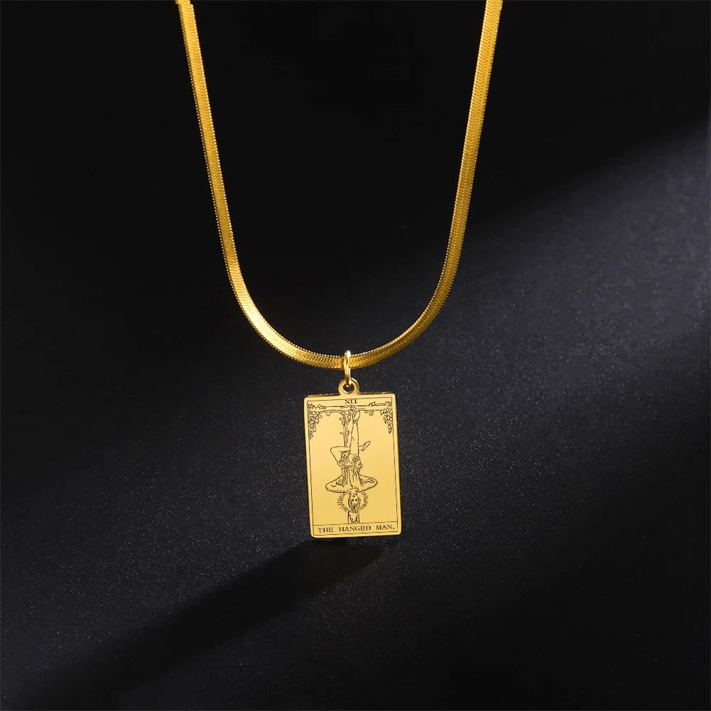 Gold necklace with a rectangular pendant on a black background