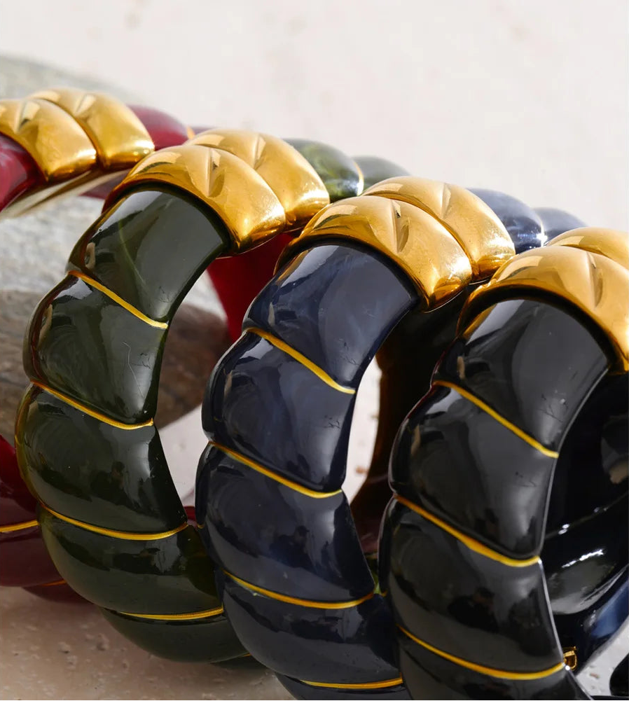 Close-up of a black, blue and green bracelet with a textured design.