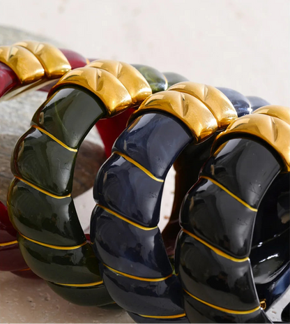 Close-up of a black, blue and green bracelet with a textured design.