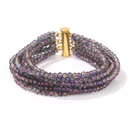 Multistrand beaded bracelet with a gold clasp on a white background