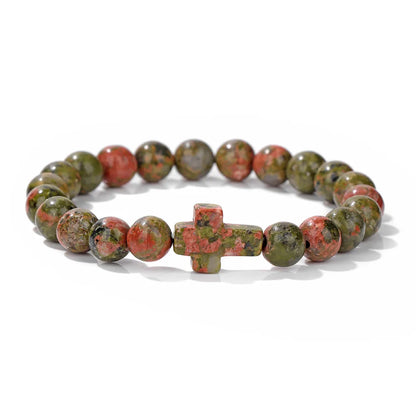 Beaded bracelet with a cross charm on a white background