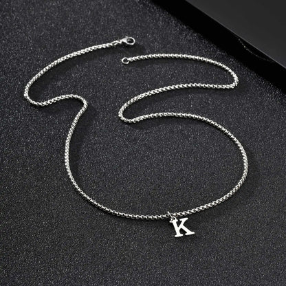 Silver chain necklace with a 'K' pendant on a black background
