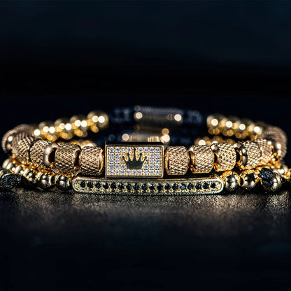 Gold bracelet with diamond accents on a dark background