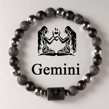 Black beaded bracelet with Gemini zodiac symbol on a light grey background