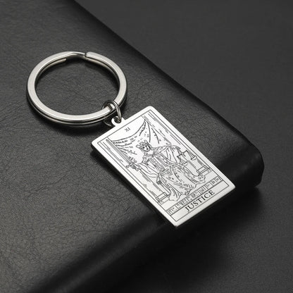 Keychain with tarot card design on a black surface