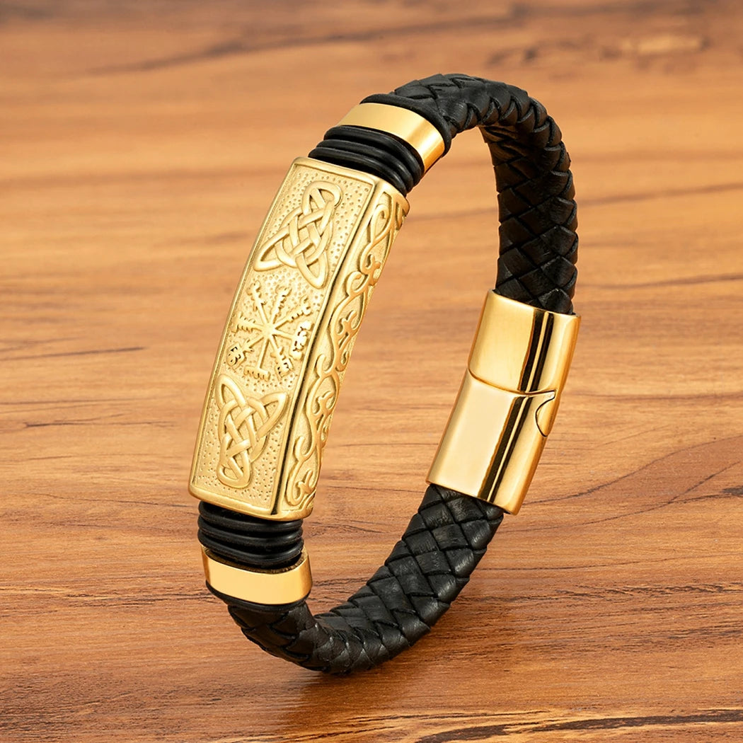 Gold and black braided bracelet on a wooden surface