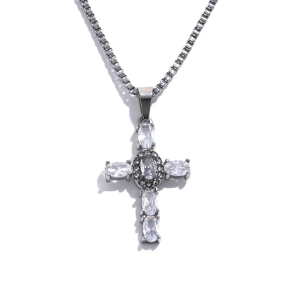 Silver cross pendant necklace with clear stones on a white background