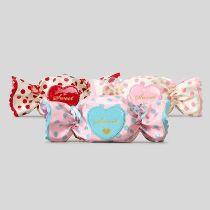 Decorative candy-shaped bags with polka dots and 'sweet' text on a light grey background