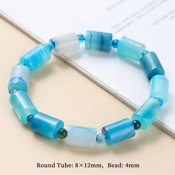 Lake Blue Striped Agate bracelet on a light beige surface.