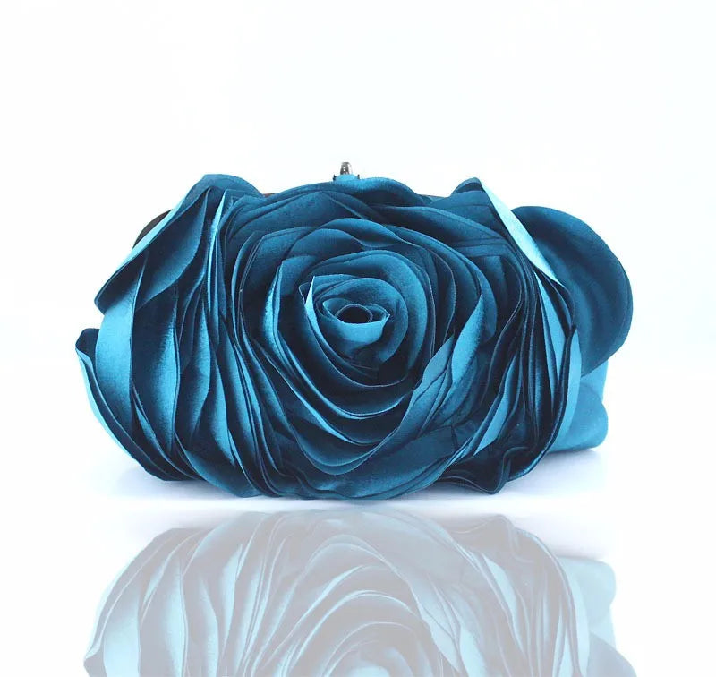 Blue rose-shaped clutch bag on a white background