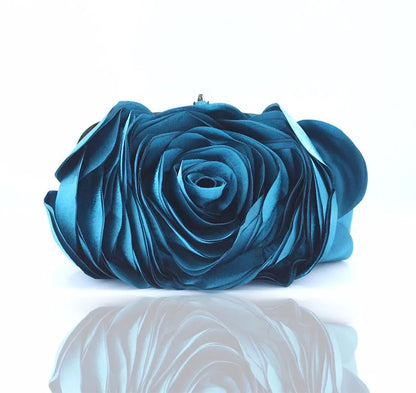 Blue rose-shaped clutch bag on a white background