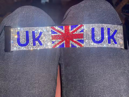 A wide bracelet strap with 'UK' and a Union Jack design on dark Blue jean fabric background.