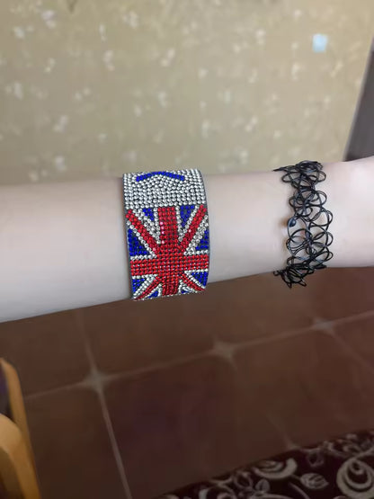 Bracelet with Union Jack design on a wrist against a tiled wall background